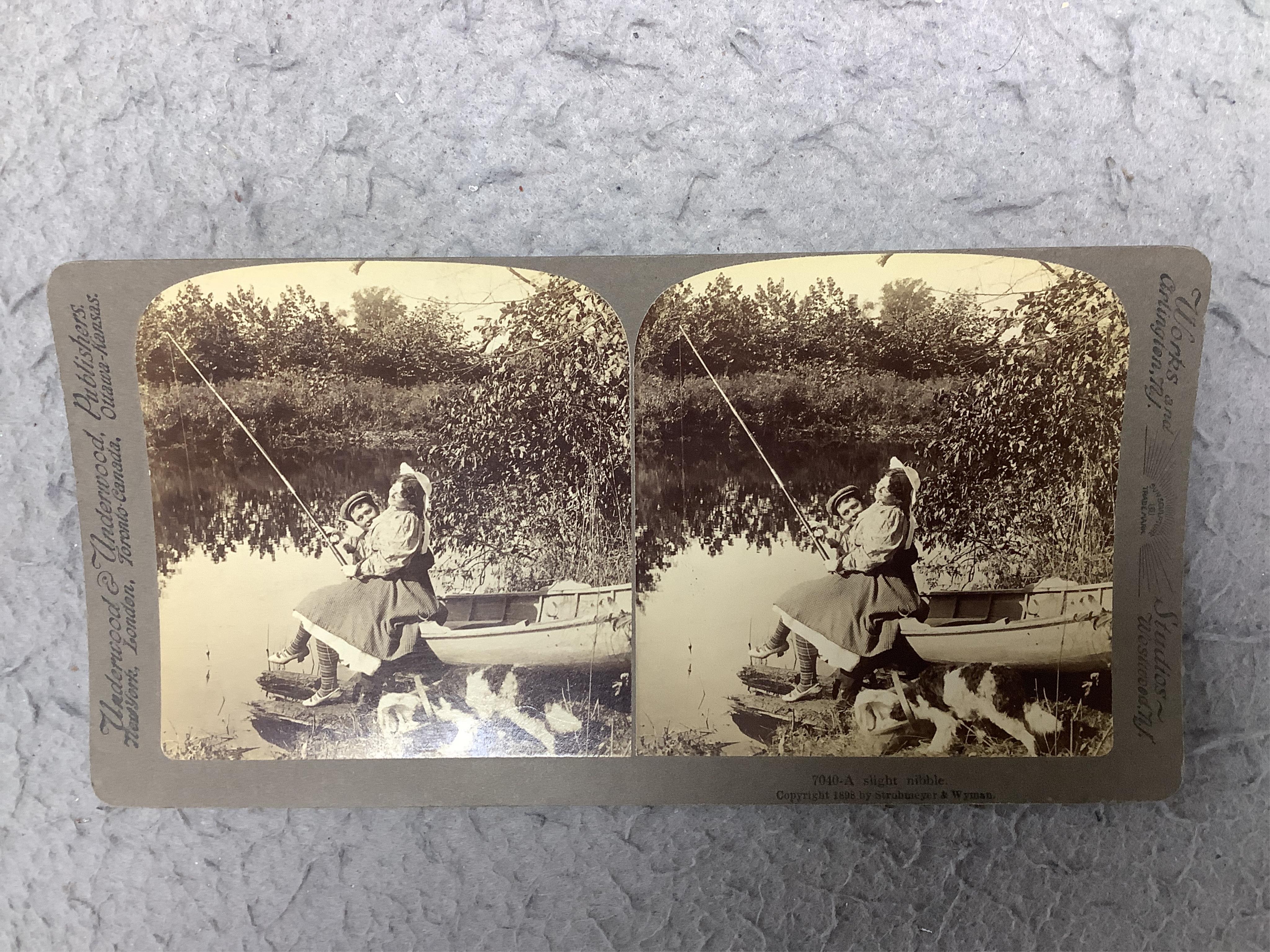 A stereoscope viewer with a collection of comical viewing cards. Condition - cards - fair/good, viewer - poor